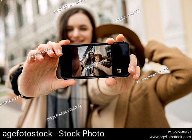Selfie of mother and daughter on smart phone screen