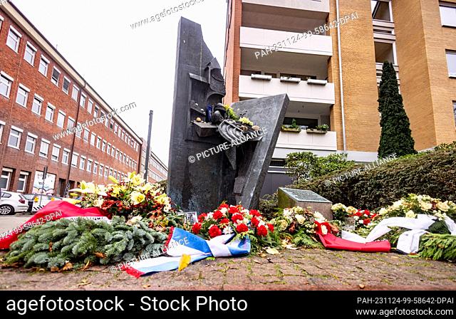 PRODUCTION - 23 November 2023, Schleswig-Holstein, Kiel: Flowers are laid at the Kiel Synagogue memorial, which stands on the site of the synagogue destroyed in...