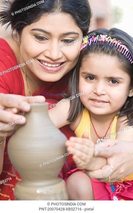 Portrait of a girl with her teacher in a pottery class