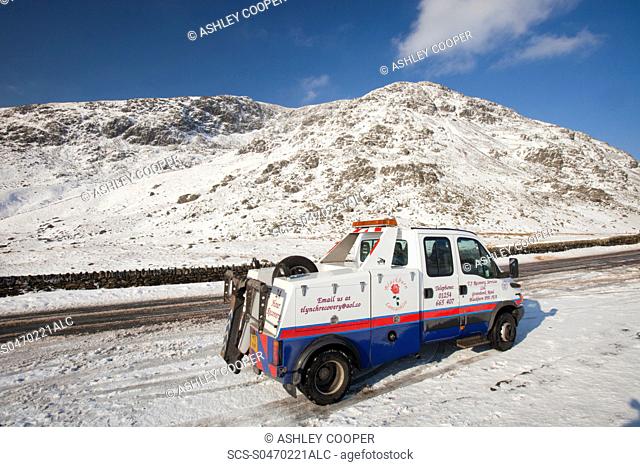 A break down recovery vehicle on Kirkstone Pass in the Lake District in Winter snow