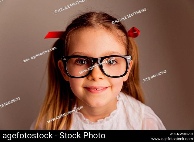 Portrait of little girl wearing oversized glasses
