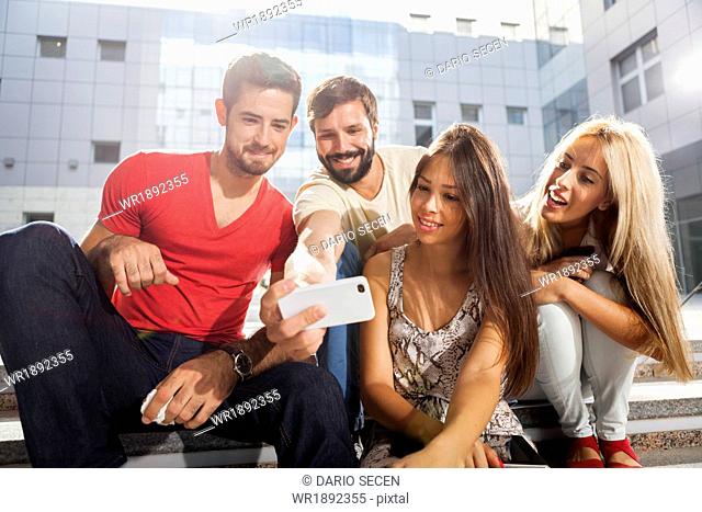 Group of students taking a self portrait with smart phone