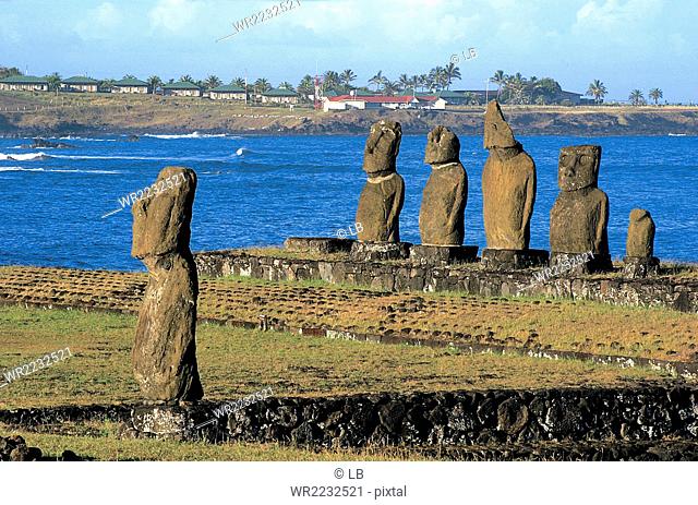 Chile, Ceremonial area of Tahai with the five Moai of the Ahu Vai Uri and solitary Ahu Tahi, Easter Island, Rapa Nui National Park, South America