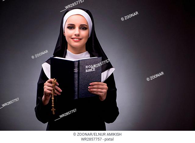 Religious nun in religion concept against dark background