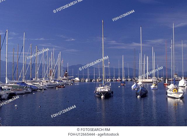 Switzerland, La Cote, Vaud, Lake Geneva, Boats docked in the harbor along the lakefront in the town of Morges on Lac Leman