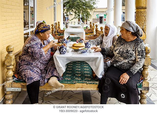 A Small Group Of Uzbek Women Eating Lunch At A Cafe Inside The Main Bazaar, Samarkand, Uzbekistan