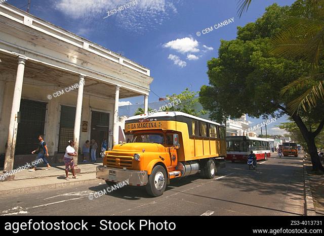 Vehicles in front of the colonial buildings at Paseo del Prado or so called Boulevard, Cienfuegos, Cuba, Central America