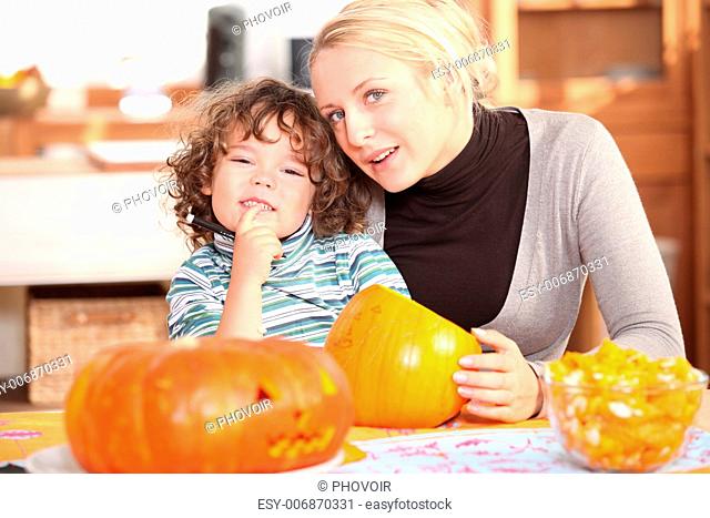 Mother and child carving pumpkins