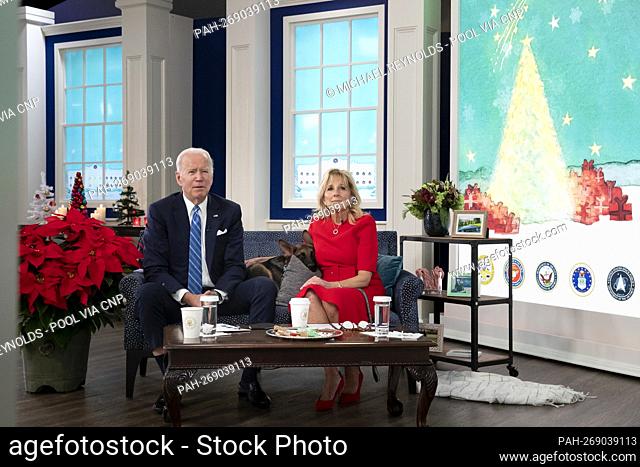 United States President Joe Biden, left, and first lady Dr. Jill Biden, right, sit with their dog, a German Shepherd puppy named 'Commander’, center