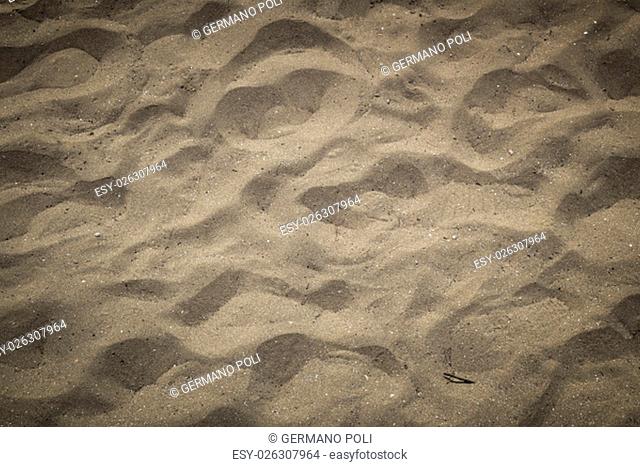 Backdrop of sea sand with footprints