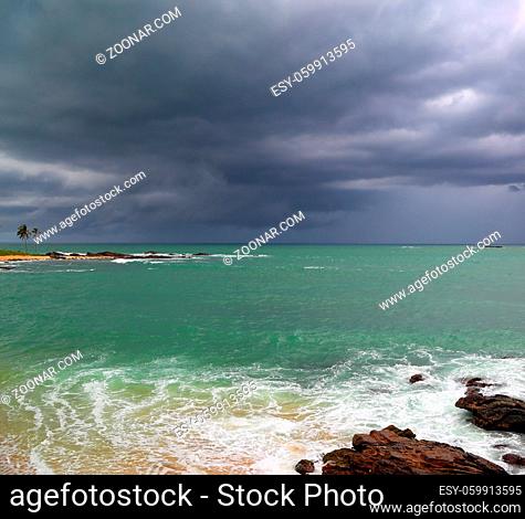 Beautiful sea stormy landscape over rocky coastline in Indian ocean