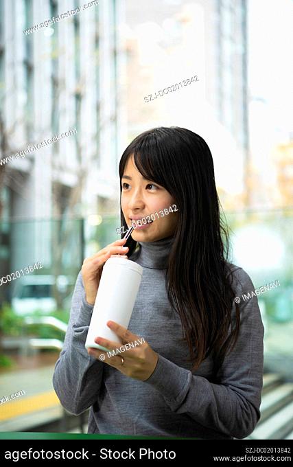 Woman drinking reusable straw