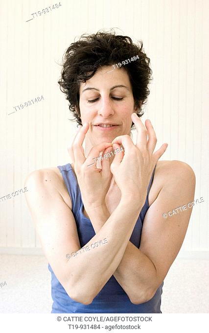 Woman doing yoga in a studio  Pose: 'mudra'  MR