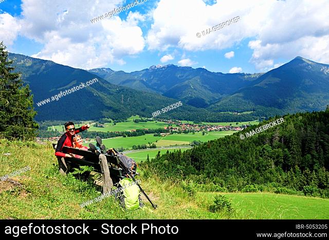 Hikers enjoy the view from alpine restaurant Streichen of Schleching and the Kampenwand, Chiemgau, Upper Bavaria, Bavaria, Germany, Europe