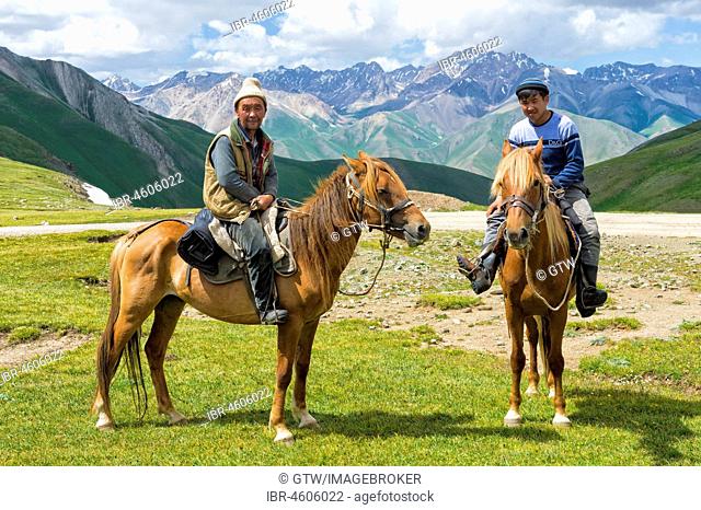Two Kyrgyz riders, Road to Song Kol Lake, Naryn province, Kyrgyzstan, Central Asia