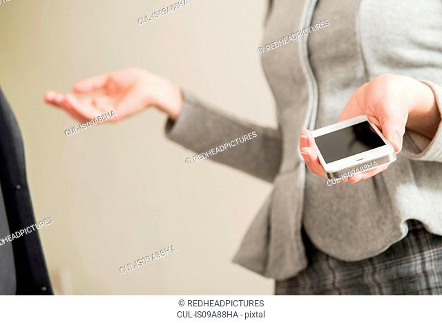 Woman holding smartphone, close up