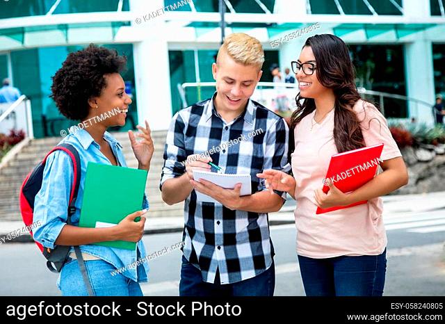 Latin american and african female students with caucasian classmate outdoors in the city