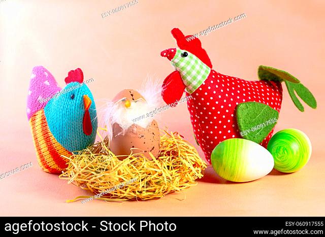 Composition of Easter eggs, textile chickens and chick in the nest with copy space. Concept of interior decoration for Easter