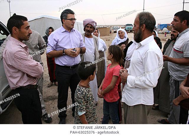 German Traumatologist Jan Ilhan Kizilhan speaking to Yazidi refugees on the outskirts of the northern town of Khanike, Iraq, 7 October 2015