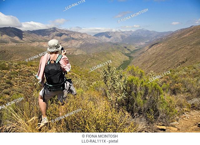Hiker on Donkey Trail looking out towards Gamkaskloof, Karoo, Western Cape Province, South Africa