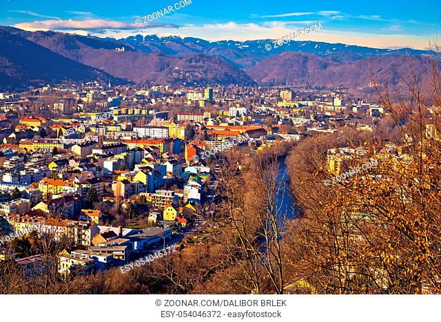 Graz and Mur river aerial cityscape view, mountains under snow backgroung, Styria region of Austria