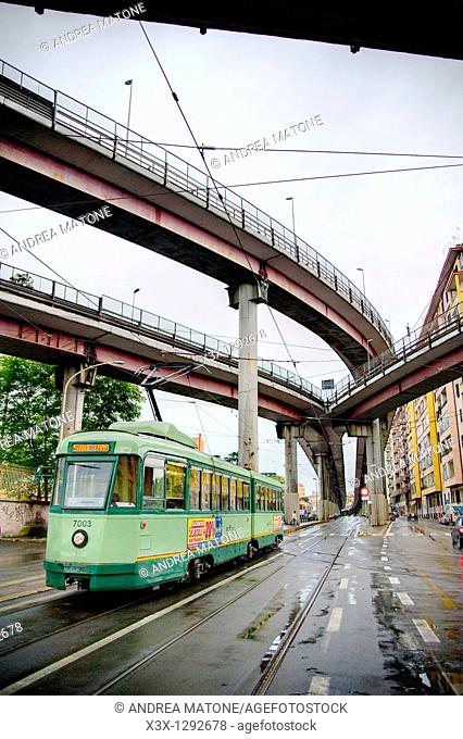 Via Prenestina with a trolley car underneath highway Tangenziale Est in Rome Italy