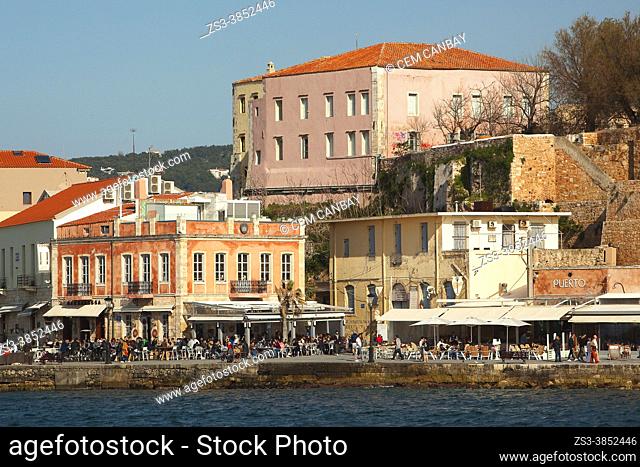 View to the Venetian style waterfront houses and traditional restaurants by the harbor in Chania city, Chania Province, Crete, Greek Islands, Greece, Europe
