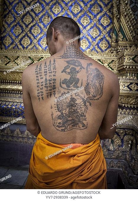 Tattooed back of a Buddhist monk at the Phra Phuttahabat temple. Thailand, Asia