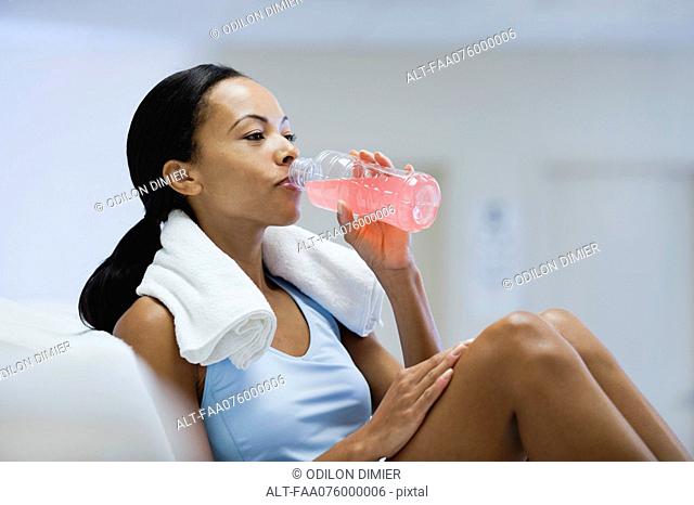 Young woman drinking sports drink