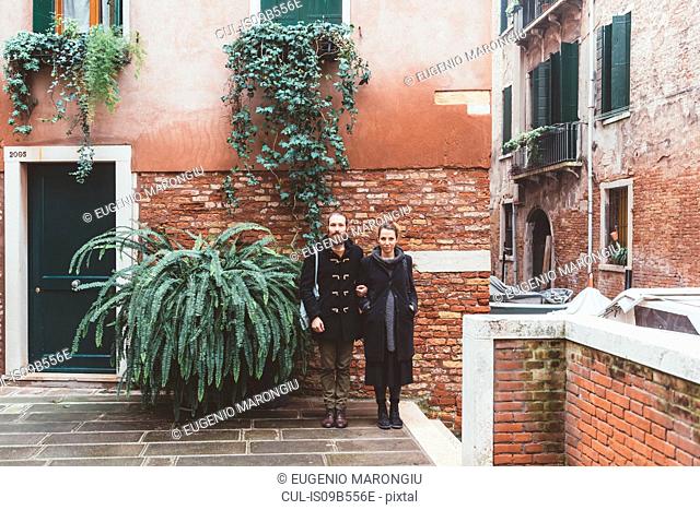 Portrait of couple in courtyard, Venice, Italy