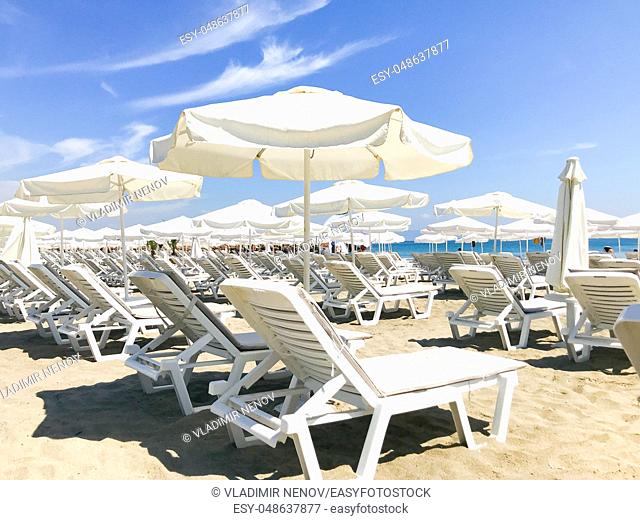 White Loungers And Umbrellas At The Beach In Pomorie, Bulgaria