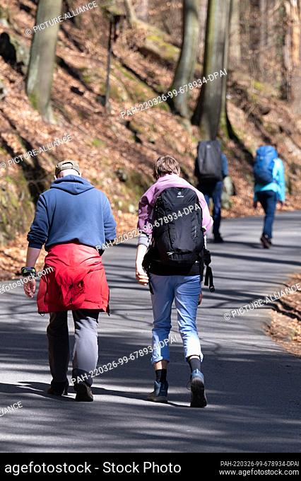 23 March 2022, Saxony, Schmilka: People walk along a hiking trail in the Saxon Switzerland National Park. Despite the ongoing Corona pandemic