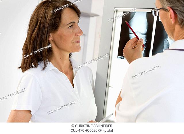 Doctor and nurse examining x-rays