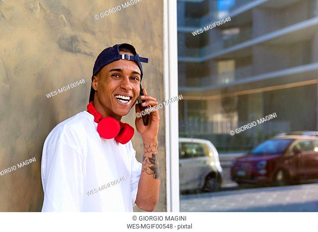 Portrait of tattooed young man on the phone