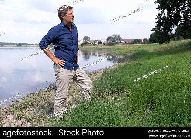 18 August 2020, Saxony, Zeithain: Robert Habeck, federal chairman of Bündnis 90/Die Grünen, is standing on the banks of the Elbe during a summer tour