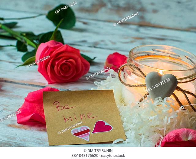 Burning candle and pink rose. love card. Valentine's Day postcard