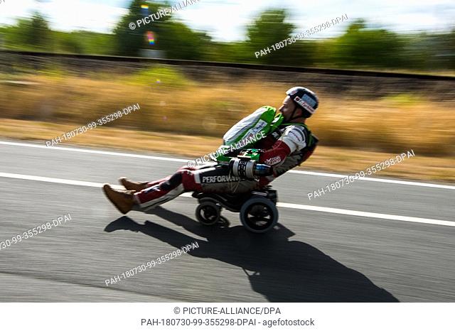 29 July 2018, Germany Darmstadt: Dirk Auer, extreme athlete, drives his jet-powered Bobby car oalong the test track. Dirk Auer