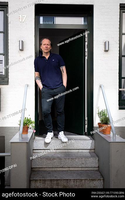20 April 2020, Hamburg: Michel Ruge, martial artist, actor and author, is standing in the entrance of his house in a side street of the Reeperbahn