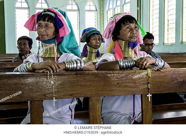 Myanmar (Burma), Kayah state, Kayan tribe (Padaung), Loikaw city, Christ the King Church, Moe Bu and Moe Su named giraffe-women are praying