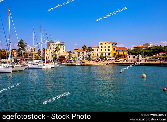Alghero, Sardinia / Italy - 2018/08/10: Summer view of the Alghero Marina yacht port at the Gulf of Alghero at Mediterranean Sea with the Old Town quarter with...