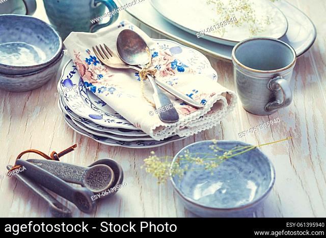 Sustainability concept - stoneware and kitchenware on wooden kitchen table