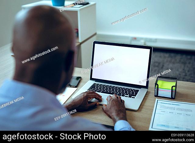 African american businessman sitting at desk using laptop having video call