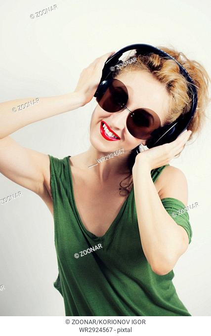 Woman wearing sunglasses and wireless headphones