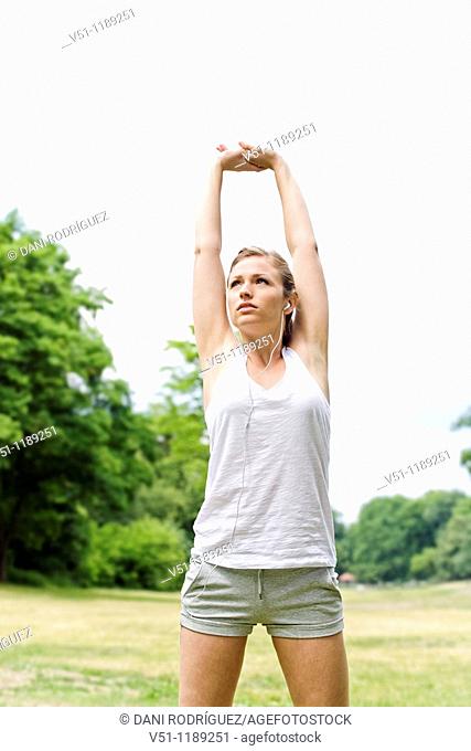 Blonde woman stretching in the park