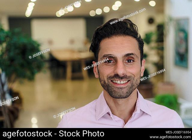 Happy mature businessman in office
