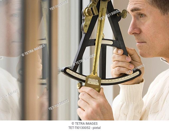 Man measuring angle with sextant