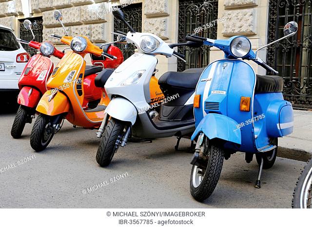 Vespas parked in a row in a back road, Vienna, Austria