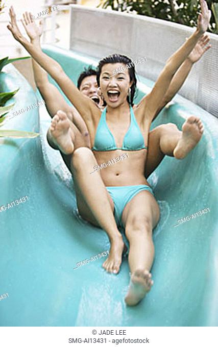 Couple going down water slide.