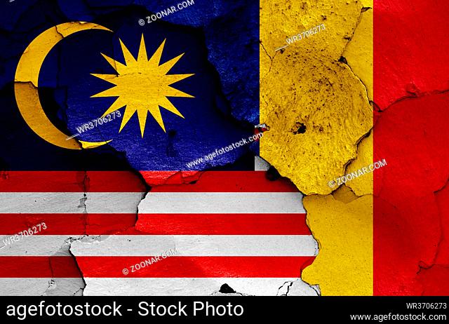 flags of Malaysia and Romania painted on cracked wall
