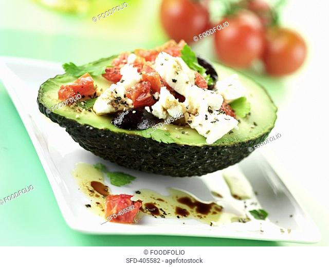 Mozzarella and tomato salad with black olives in avocado Not available for exclusive usages